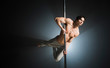 Portrait of young male model pole dancing