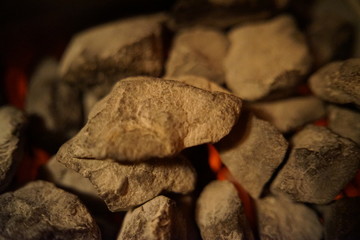 Hot glowing red burning stones inside the sauna oven, stov