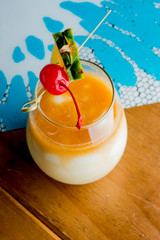 Frozen pina colado. Traditional classic Hawaiian or tiki bar tropical drinks. Drinks w/  dark aged rum, blanco tequila, amaretto, garnished w/ limes pineapple cherries coconuts served frozen.