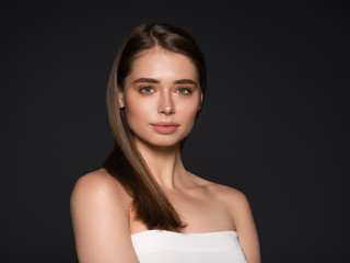 beauty woman natural skin hair studio shot of a beautiful young woman posing against a dark backgrou
