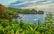 A beautiful secluded bay near Hilo, Hawaii, with lush tropical vegetation and picturesque scenery.