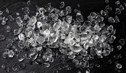 Wall Mural - pile of crushed ice on black stone background