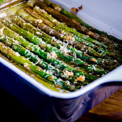 Green juicy asparagus is in ceramic form in olive oil