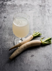 Wall Mural - Healthy Fresh daikon juice or Mooli extract drink in a glass with raw mule