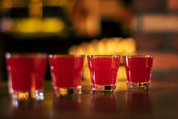 Wall Mural - red vodka shots on wooden table