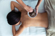 © nenetus - Young woman applying chocolate cream with natural ingredients for body treatment to a pretty woman on the spa center.