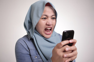 Wall Mural - Muslim Woman Angry While Reading Text Message on Smart Phone