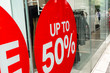 © AmpYang Images - Red Sale Sign Sticker on the outside of Fashion Store Windows