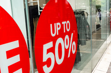 Red Sale Sign Sticker On The Outside Of Fashion Store Windows