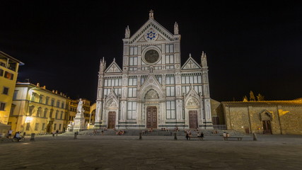 Wall Mural - Tourists on Piazza di Santa Croce at night timelapse  with Basilica di Santa Croce Basilica of the Holy Cross in Florence city.