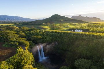 Hawaiian waterfall in front of Mountains, sunny morning beautiful lush greenery