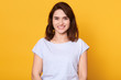 © sementsova321 - Head shot portrait of young woman having wide white smile, wearing white t shirt, lady looking at camera, pretty female posing isolated over bright yellow background, girl expressing happyness.