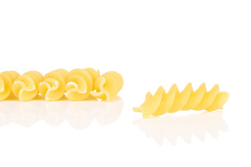 Wall Mural - Group of six whole yellow pasta fusilli isolated on white background