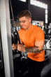 © JonoErasmus - Fit young man doing cable tricep pulldowns at the gym