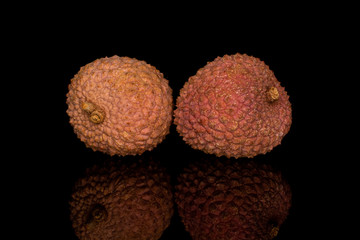 Wall Mural - Group of two whole fresh lychee isolated on black glass