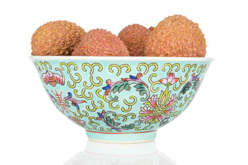 Wall Mural - Lot of whole fresh lychee with blue chinese ceramic bowl isolated on white background