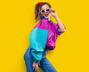 cool teenager. fashionable dj girl in colorful trendy jacket and vintage retro sunglasses enjoys sty