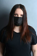 © евгений ставников - a girl in a black mask from a cold and a virus.the vaccine for coronavirus