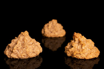 Wall Mural - Group of three whole homemade brown coconut biscuit with chocolate isolated on black glass