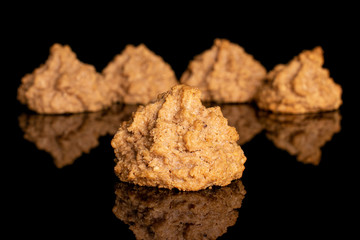 Wall Mural - Group of five whole homemade brown coconut biscuit with chocolate isolated on black glass