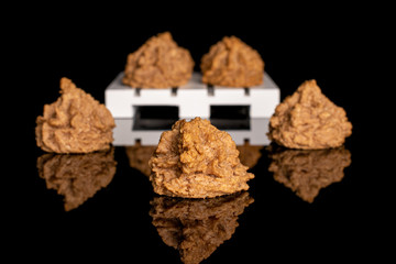 Wall Mural - Group of seven whole homemade brown coconut biscuit with chocolate on white wooden pallet isolated on black glass