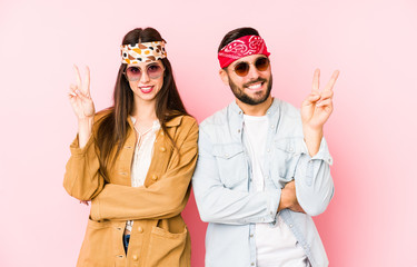 Wall Mural - Young caucasian couple wearing a music festival clothes isolated showing number two with fingers.