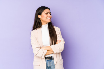 Wall Mural - Young indian woman isolated on purple background smiling confident with crossed arms.
