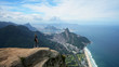 © vadim_ozz - Happy traveler on the top of Pedra da Gavea mountain with panoramic aerial view to the Rio de Janeiro landscape in Brazil.