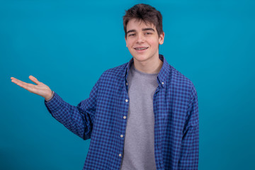 teenager or student isolated on color background pointing