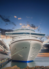 Canvas Print - A luxury cruise ship tied up at a tropical port in a calm bay