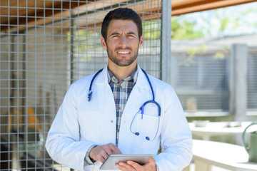 picture of male veterinarian holding tablet