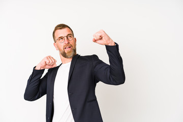 Senior business man isolated on white background raising fist after a victory, winner concept.