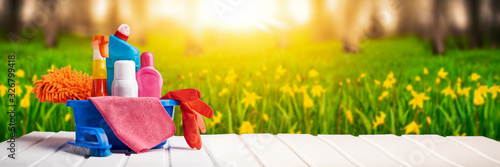 Fotomural Cleaning supplies and chemicals on nature background web banner: spring cleaning