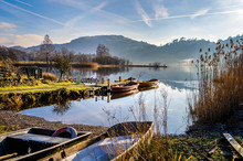 Boats At Rest On Grasmere Water By The Village In The Centre Of The Lake District Cumbria. . 