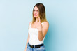 © Asier - Young caucasian woman isolated on blue background pointing with finger at you as if inviting come closer.
