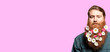 © nick_fedirko - A happy man with a beautiful red beard decorated with flowers on the pink background.  Holiday card. Congratulation holiday card. Holiday banner. Spring card.