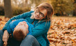© Strelciuc - Caucasian mother looking through eyeglasses at her small son during an autumn walk in the park among the leaves