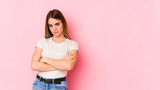 Fototapeta Panele - Young caucasian woman isolated on pink background who is bored, fatigued and need a relax day.