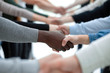 © ASDF - close up. diverse young people shaking hands with each other.