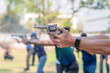© Mongkolchon - man hands holding and fire hand gun in gun shooting competition