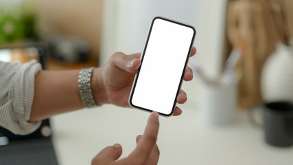 Wall Mural - Close up view of male designer showing blank screen smartphone