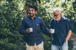 © chokniti - Father-son bonding. Cheerful young man drinking coffee together with him