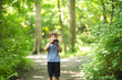 © digitalskillet1 - Young boy taking photo in the forest.