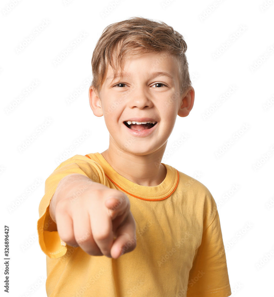 Happy little boy pointing at viewer on white background