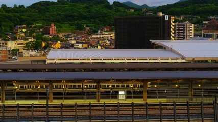 Sticker - Kumamoto, Japan. Aerial view of a train station in a popular touristic city of Kyushu island Kumamoto, Japan in the morning. Time-lapse at sunrise, panning video