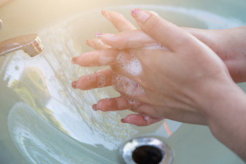 Wall Mural - Women wash their hands properly before eating