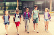 © Syda Productions - primary education, friendship, childhood, communication and people concept - group of happy elementary school students with backpacks walking and talking outdoors