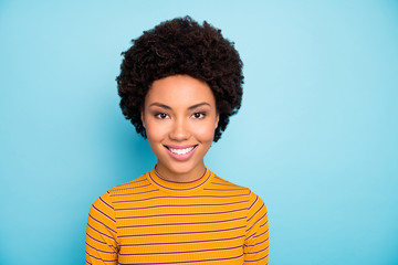 Canvas Print - Photo of beautiful pretty dark skin wavy lady toothy beaming smiling positive good mood nice easy-going person wear striped pullover isolated blue color background