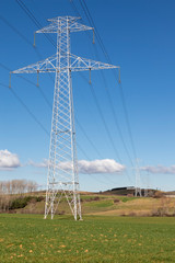 Electric pole, electricity tower station over blue sky and clouds.