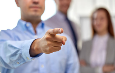 business, gesture and people concept - close up of businessman pointing finger